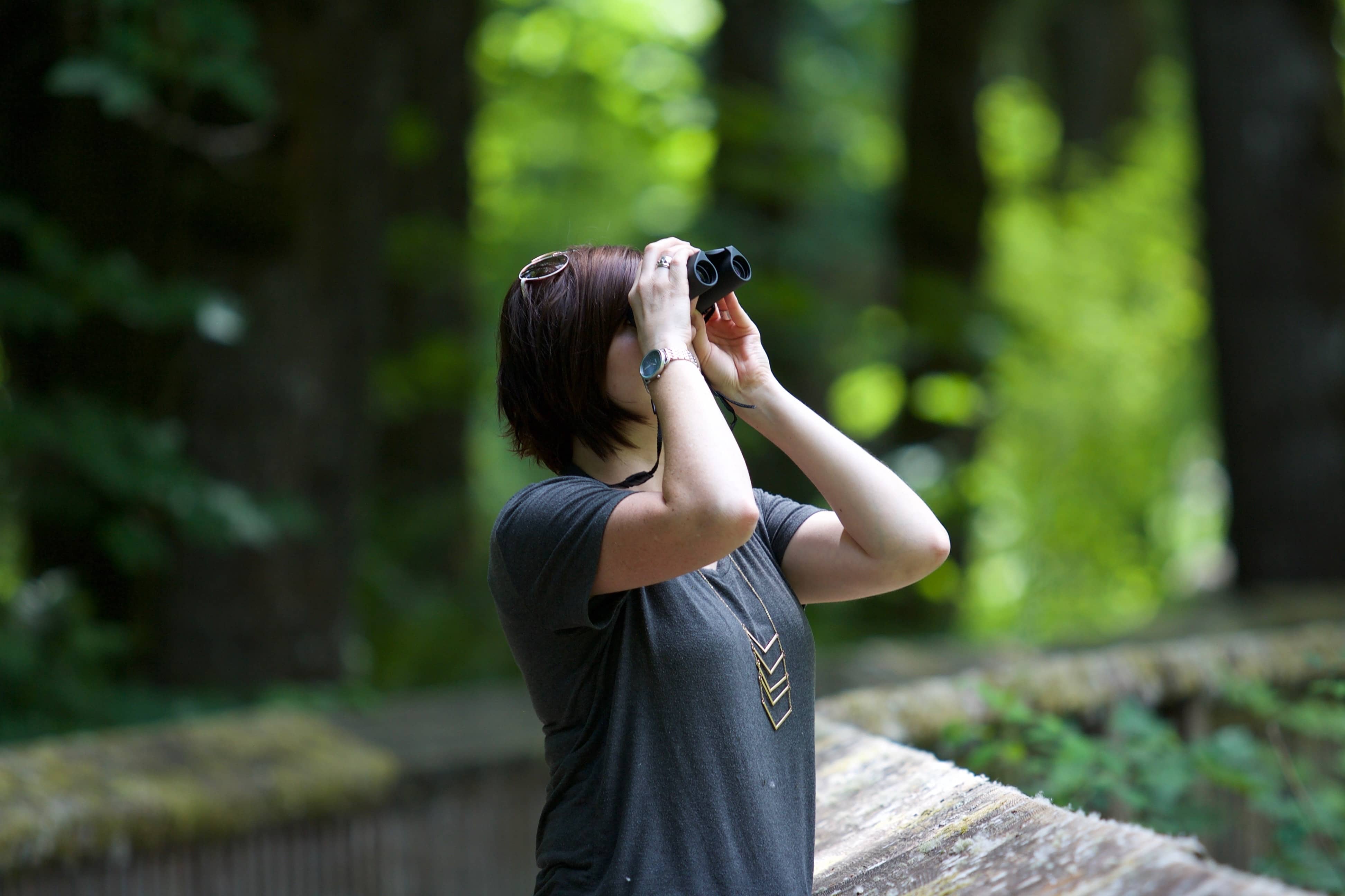 a woman holding binoculars