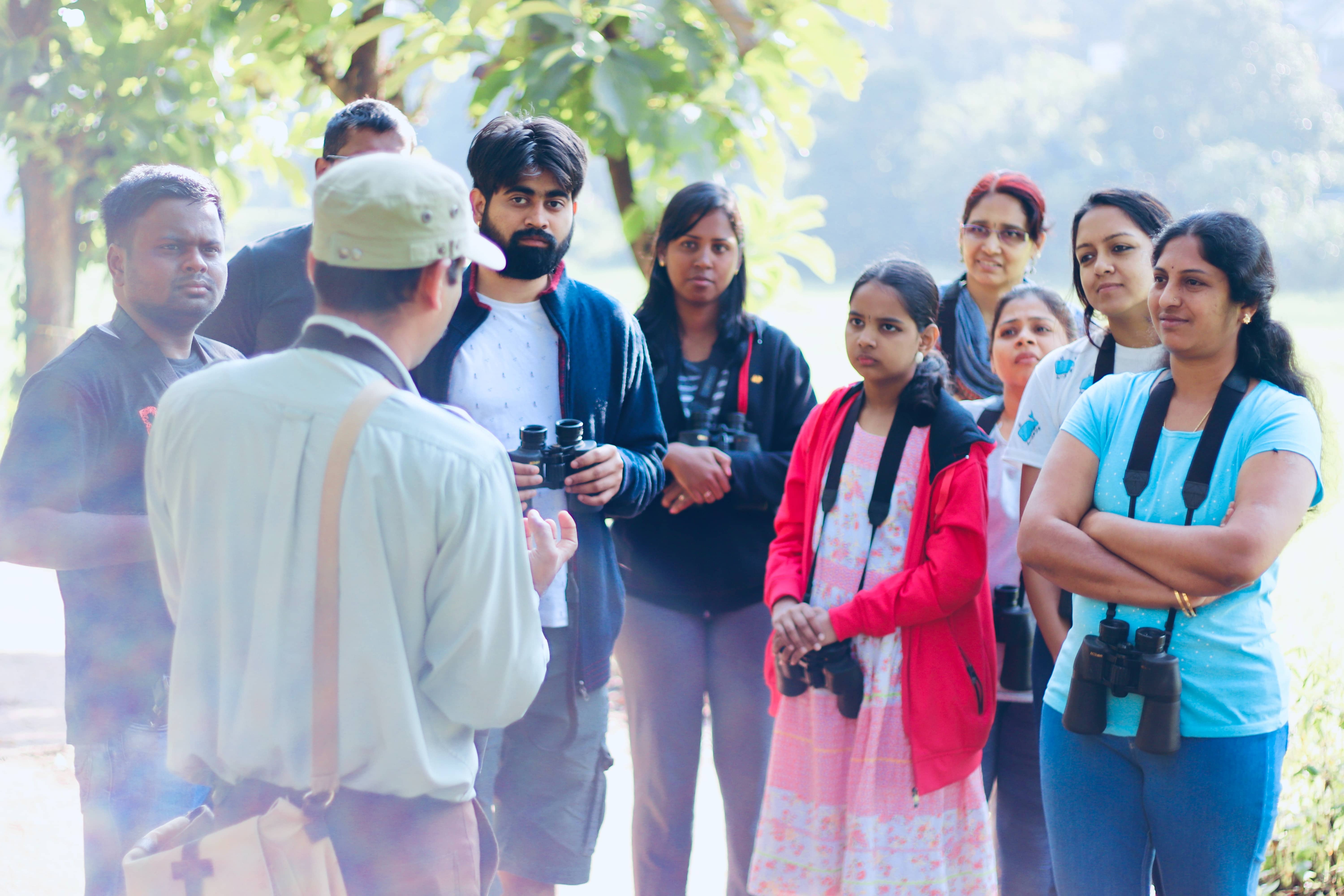 a guide talking to a group of birders